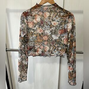 Sheer floral long sleeve crop top shirt with mock turtle neck detail.